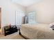 Cozy bedroom with neutral tones, a comfortable bed, and ample closet space at 123 Evergreen Dr, Auburndale, FL 33823