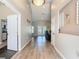 Inviting hallway with wood-look flooring leads to the living area and features a high ceiling at 123 Evergreen Dr, Auburndale, FL 33823