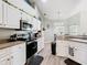 Kitchen with stainless appliances and white cabinets at 123 Evergreen Dr, Auburndale, FL 33823