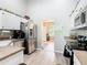 Bright kitchen with stainless steel appliances and decorative accents on top of cabinets at 123 Evergreen Dr, Auburndale, FL 33823