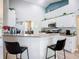 Bright kitchen with white cabinetry, stainless steel appliances, and an eat-in breakfast bar with seating at 123 Evergreen Dr, Auburndale, FL 33823