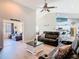 Spacious living room featuring vaulted ceiling, and flows into the kitchen and game room at 123 Evergreen Dr, Auburndale, FL 33823