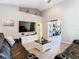 Comfortable living room featuring a ceiling fan, and an open doorway to the game room at 123 Evergreen Dr, Auburndale, FL 33823