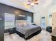 Inviting main bedroom with tray ceiling, dark accent wall, and natural light from the windows at 123 Evergreen Dr, Auburndale, FL 33823