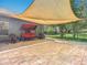 Covered brick patio with comfortable seating, perfect for outdoor relaxation and entertaining at 123 Evergreen Dr, Auburndale, FL 33823