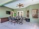 Covered outdoor dining area with a ceiling fan for comfortable entertaining at 123 Evergreen Dr, Auburndale, FL 33823
