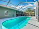 Sparkling screened-in pool offers a refreshing escape and year-round enjoyment at 123 Evergreen Dr, Auburndale, FL 33823