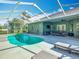 Private screened-in pool area with ample seating and a beautiful view at 123 Evergreen Dr, Auburndale, FL 33823