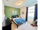 Bright bedroom with dinosaur themed bedding, and cheerful decor at 1363 Benevento Dr, Winter Haven, FL 33884