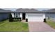 Charming single-story home with a brick driveway and well-maintained landscaping at 1363 Benevento Dr, Winter Haven, FL 33884