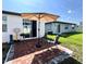 Back patio features brick pavers, an umbrella, and space to grill at 1363 Benevento Dr, Winter Haven, FL 33884