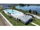 Aerial view of community pool with palm trees and comfortable lounge chairs at 1363 Benevento Dr, Winter Haven, FL 33884