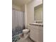 Bathroom with shower, white vanity, and patterned shower curtain at 1378 Fox Squirrel Dr, Davenport, FL 33897