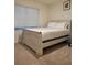 Bright bedroom featuring a whitewashed wood bed frame and plush carpeting at 1378 Fox Squirrel Dr, Davenport, FL 33897