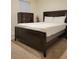 Comfortable bedroom featuring a sleek, dark wood bed frame and soft carpet at 1378 Fox Squirrel Dr, Davenport, FL 33897