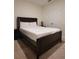 Bedroom with sleek, dark wood bed frame and soft carpet at 1378 Fox Squirrel Dr, Davenport, FL 33897