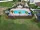 Aerial view of the community pool, hot tub and gathering area surrounded by lush landscaping at 1378 Fox Squirrel Dr, Davenport, FL 33897