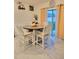 Inviting dining area with a wood table, cushioned chairs, and sliding glass door at 1378 Fox Squirrel Dr, Davenport, FL 33897