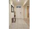 Inviting foyer with neutral tones, decorative mirror, and a view into the adjacent living spaces at 1378 Fox Squirrel Dr, Davenport, FL 33897