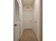 Well-lit hallway with carpet flooring and access to multiple rooms at 1378 Fox Squirrel Dr, Davenport, FL 33897