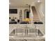 Bright kitchen with a stainless steel sink overlooking the living area and staircase at 1378 Fox Squirrel Dr, Davenport, FL 33897