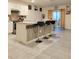 Modern kitchen featuring a center island with bar seating, sleek countertops, and tiled backsplash at 1378 Fox Squirrel Dr, Davenport, FL 33897