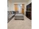 Bright living room featuring a gray sectional sofa, TV, and soft carpet at 1378 Fox Squirrel Dr, Davenport, FL 33897