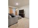 Spacious living room with large gray sectional, TV, and neutral carpet at 1378 Fox Squirrel Dr, Davenport, FL 33897