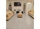 Open-concept living room boasts tile floors, a media center, and ample seating space at 1378 Fox Squirrel Dr, Davenport, FL 33897