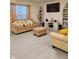 Cozy living room featuring a comfortable sofa, ottoman, and stylish decor with ample light at 1378 Fox Squirrel Dr, Davenport, FL 33897
