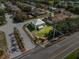 Aerial view of a green two-story home with a gray roof and fenced back yard at 1800 Emily Dr, Winter Haven, FL 33884