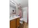 Bathroom featuring wood-look floors, a shower/tub combo, vanity, toilet, and vanity lighting at 1800 Emily Dr, Winter Haven, FL 33884