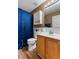 Cozy bathroom featuring wooden cabinets, tile backsplash, and a framed mirror with vanity lighting at 1800 Emily Dr, Winter Haven, FL 33884