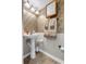 Bathroom featuring pedestal sink, decorative towels, and tile flooring at 1800 Emily Dr, Winter Haven, FL 33884