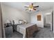 Cozy bedroom with neutral carpeting, a ceiling fan, double closet doors, and nice natural light at 1800 Emily Dr, Winter Haven, FL 33884