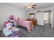 Charming bedroom with gray carpeting, a ceiling fan, and a large window at 1800 Emily Dr, Winter Haven, FL 33884