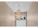Elegant, tiered chandelier hanging in a two-story foyer at 1800 Emily Dr, Winter Haven, FL 33884