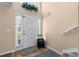 Bright foyer with a tile floor, coat closet, stairs, and white front door with sidelight windows at 1800 Emily Dr, Winter Haven, FL 33884