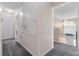 Hallway featuring carpet and neutral-toned walls with a glimpse of a chandelier at 1800 Emily Dr, Winter Haven, FL 33884
