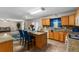Kitchen features wood cabinets, granite countertops, and a breakfast bar at 1800 Emily Dr, Winter Haven, FL 33884