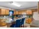 Well-lit kitchen featuring wood cabinets, granite countertops, and a breakfast bar at 1800 Emily Dr, Winter Haven, FL 33884
