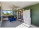 Enclosed lanai featuring a ceiling fan and views of lush greenery at 1800 Emily Dr, Winter Haven, FL 33884