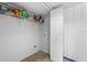 Functional laundry room with shelving for storage and tile flooring at 1800 Emily Dr, Winter Haven, FL 33884