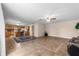Bright living room with tile flooring, ceiling fan, and open layout to the kitchen at 1800 Emily Dr, Winter Haven, FL 33884