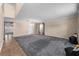 Spacious living room featuring plush gray carpeting and natural light streaming through the window at 1800 Emily Dr, Winter Haven, FL 33884