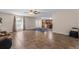Inviting living room with tile flooring, ceiling fan, and views into the adjacent kitchen at 1800 Emily Dr, Winter Haven, FL 33884