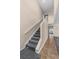 Carpeted staircase with neutral-colored walls and tile flooring at 1800 Emily Dr, Winter Haven, FL 33884