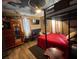 Unique bedroom with bunk beds, red bedding, and a ceiling painted with clouds and airplanes at 195 E Vine St, Bartow, FL 33830