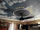 Unique bedroom with a ceiling painted with clouds and airplanes and lit by a ceiling fan at 195 E Vine St, Bartow, FL 33830