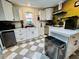 Bright kitchen featuring white cabinets, marble countertops, stainless steel appliances, and checkered floors at 195 E Vine St, Bartow, FL 33830